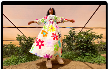 MacBook Air screen showing photo of person in colorful outfit, demonstrating color range and resolution of Liquid Retina display