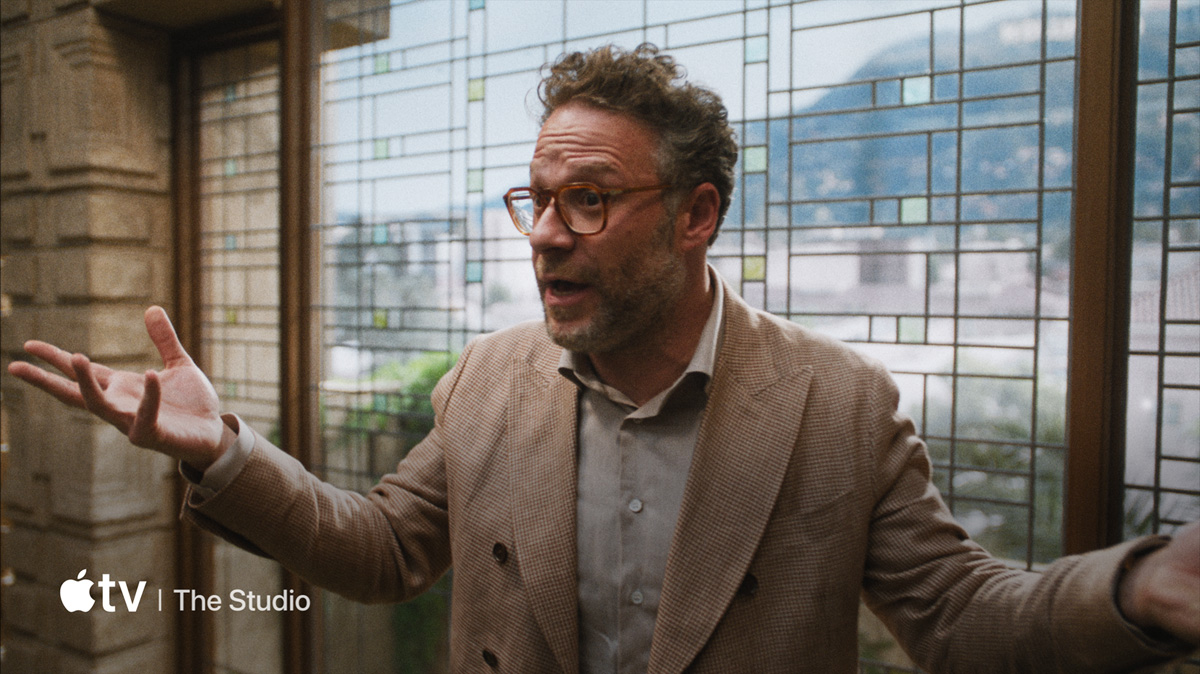 A flat-screen television showing a static image of "The Studio" available on Apple TV+