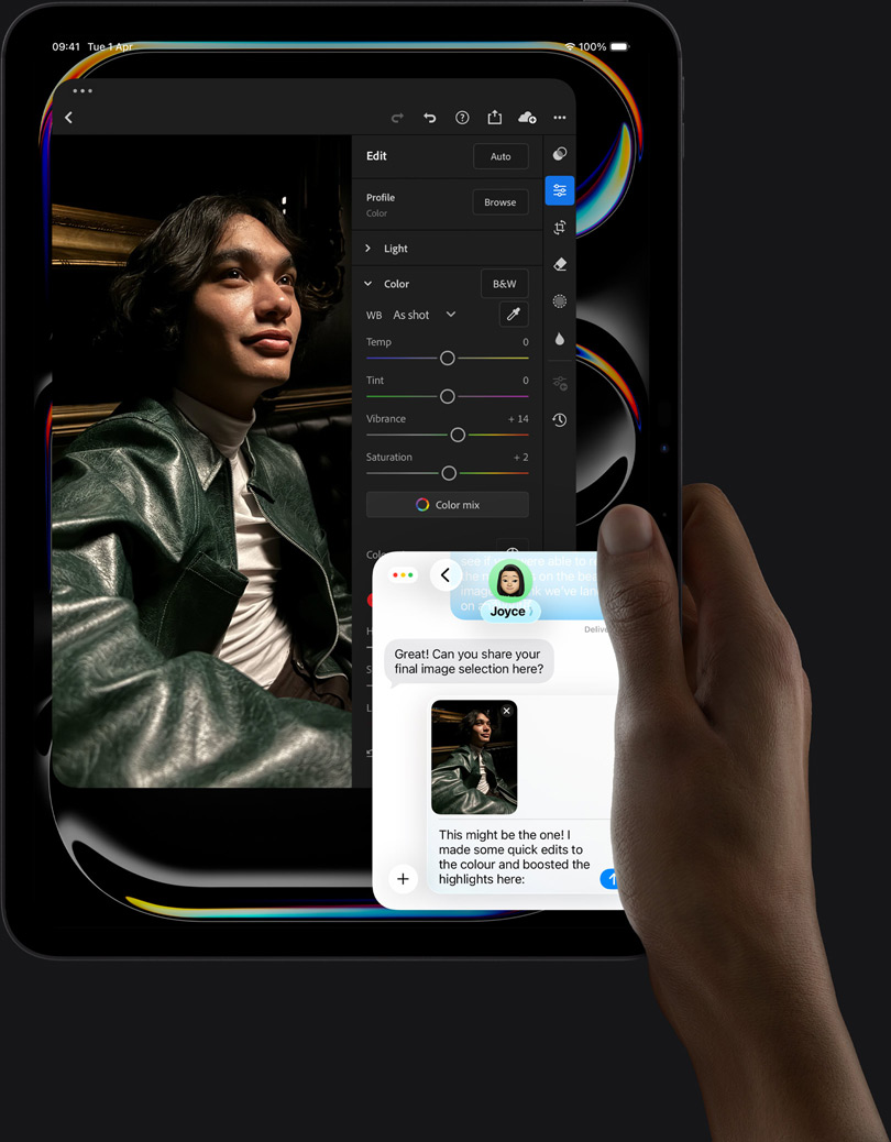 iPad Pro, front exterior, portrait orientation, space black color, right hand holding device, display showing photo editing app with image of a person in a leather jacket, editing tools and sliders,  iMessage conversation happening between user and another individual reviewing the photo
