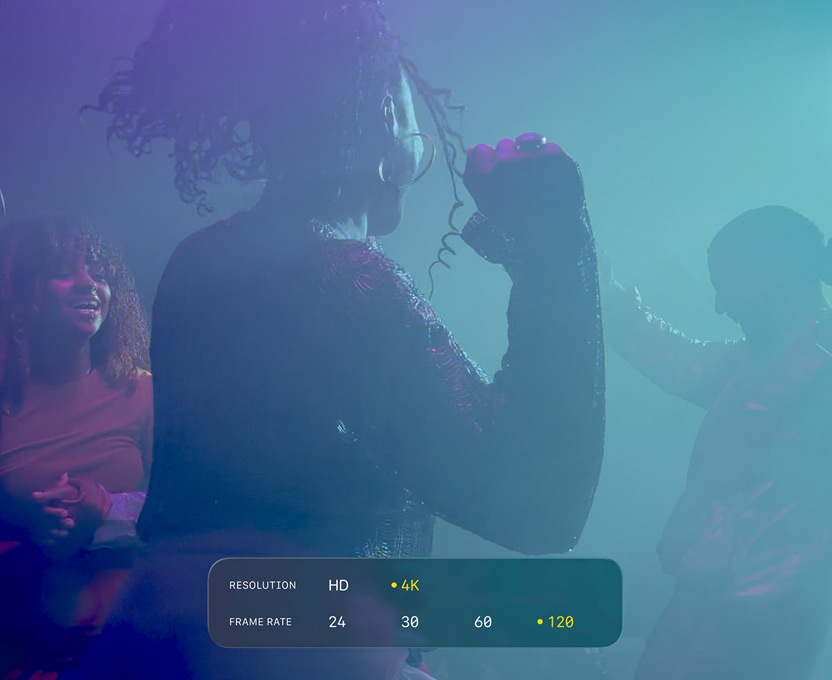 A screen of people dancing in low-light filming conditions shows the capabilities of 4K 120 fps Dolby Vision