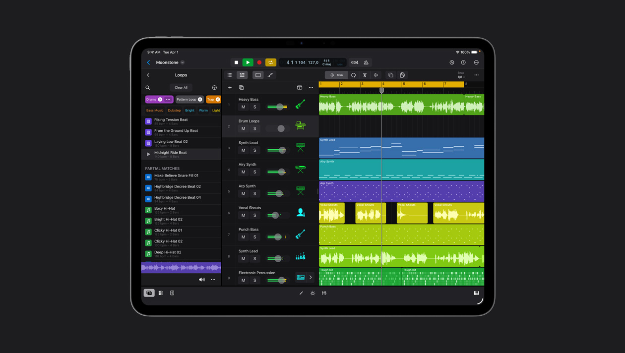 Pantalla de un iPad Pro de 13 pulgadas que muestra el espacio de trabajo de Logic Pro, panel de Loops a la izquierda, filas con ondas de sonido en diferentes colores