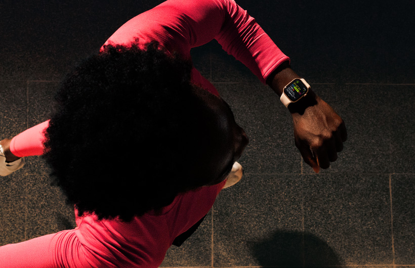 A person checks progress on Apple Watch Series 11 Workout app while running